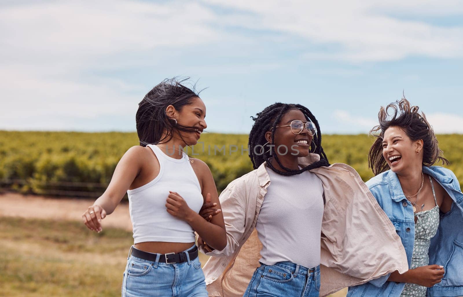 Women, friends and countryside for outdoor adventure, holiday and together for summer sunshine. Group, happy black woman and gen z students on vacation with comic laugh, support and walking in nature.