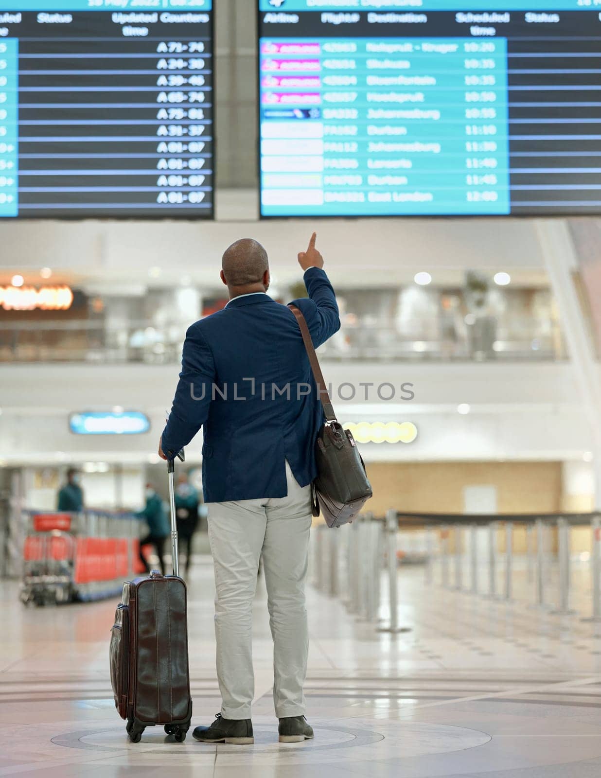 Travel, airport or black man pointing at screen with suitcase or luggage at customs in New York city. Back view, airplane or African businessman checks international flight transportation time delay.