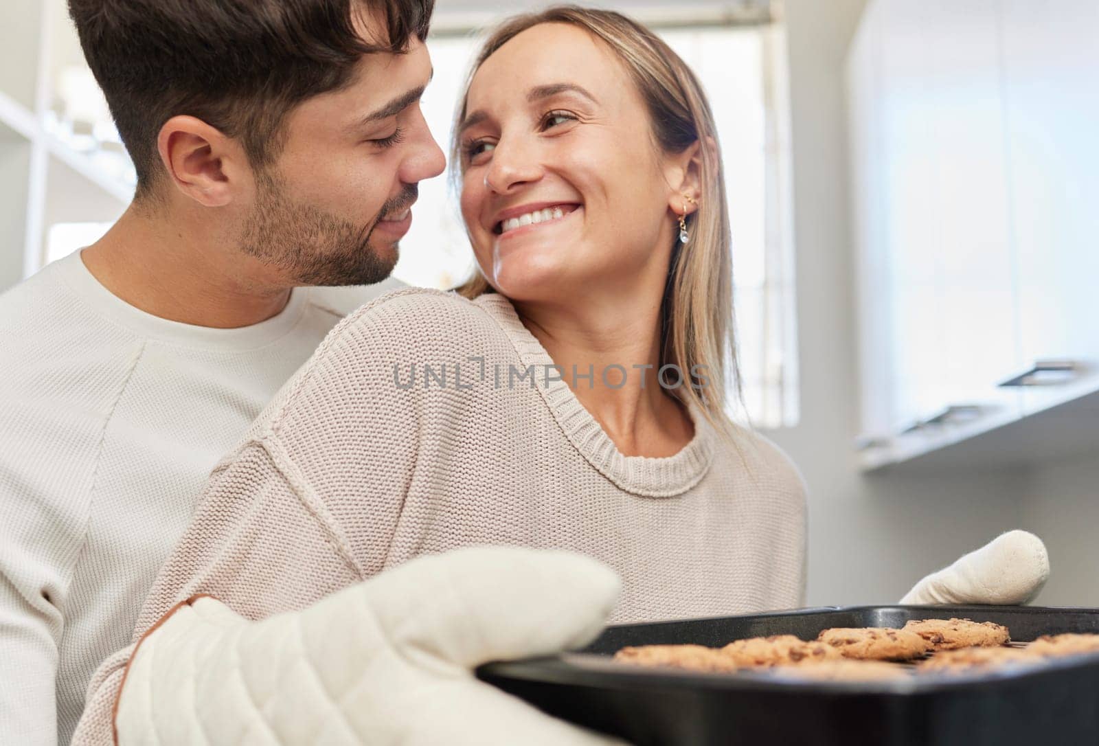 Love, kitchen and couple baking cookies together for fun, bonding and romance in their home. Bake smile and happy young man and woman preparing biscuits or snacks for party, event or dessert at house by YuriArcurs