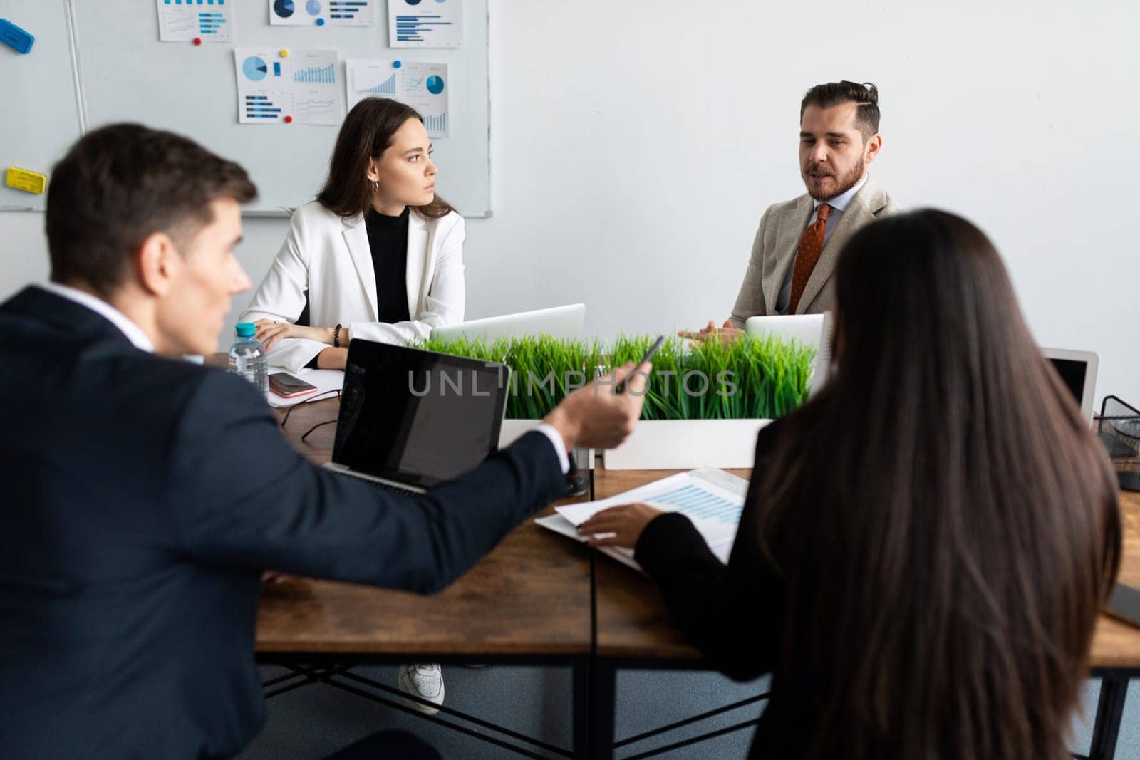 office staff decides the affairs of the company sitting at a common table.