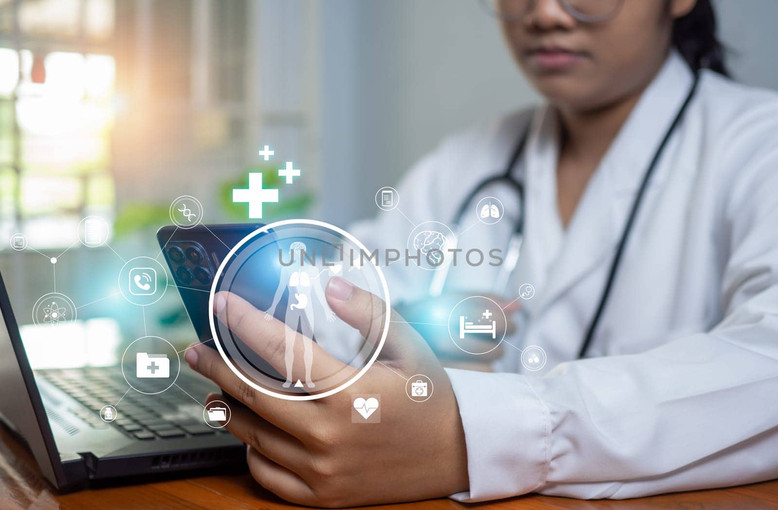 Doctors use smartphones and computers to research medical information. medical concept by Unimages2527