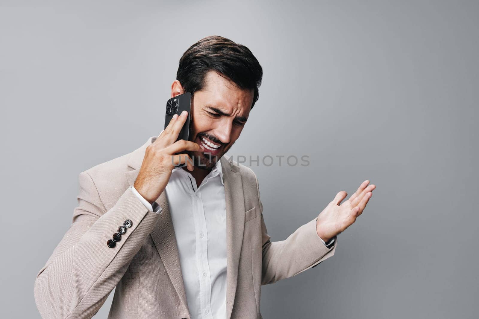 hold man angry smartphone phone connection smile portrait suit business call by SHOTPRIME