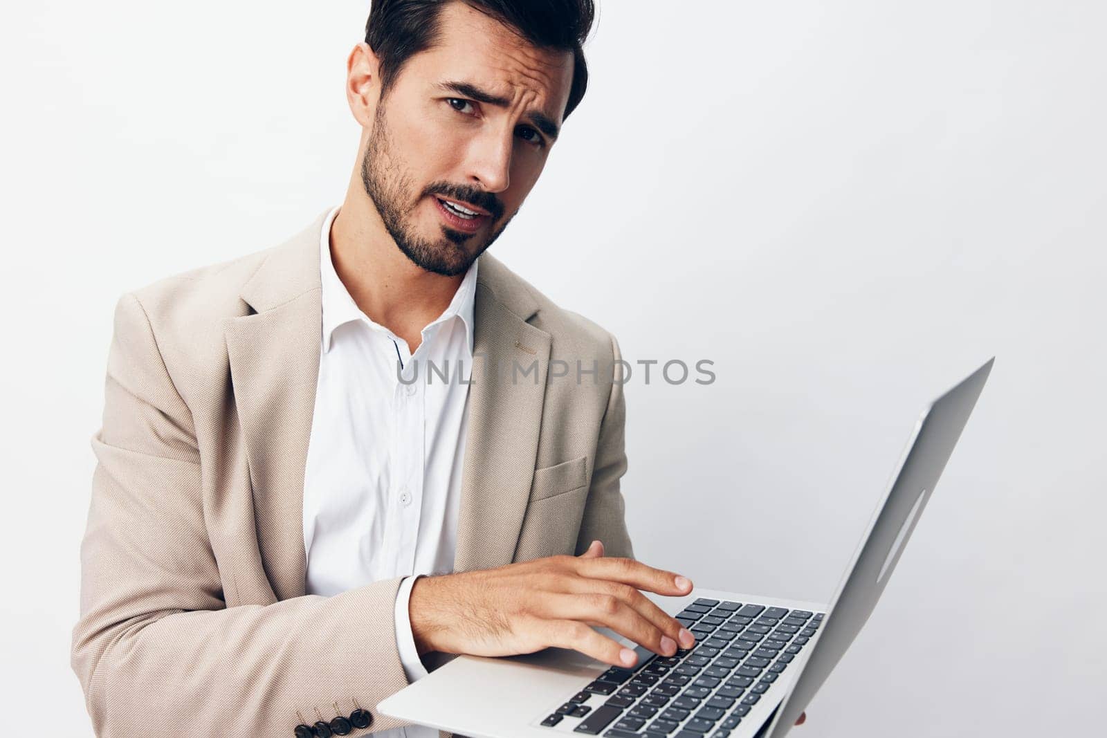 working man notebook computer suit typing online laptop cheerful internet business freelancer network copyspace thoughtful cyberspace happy stylish background job beard