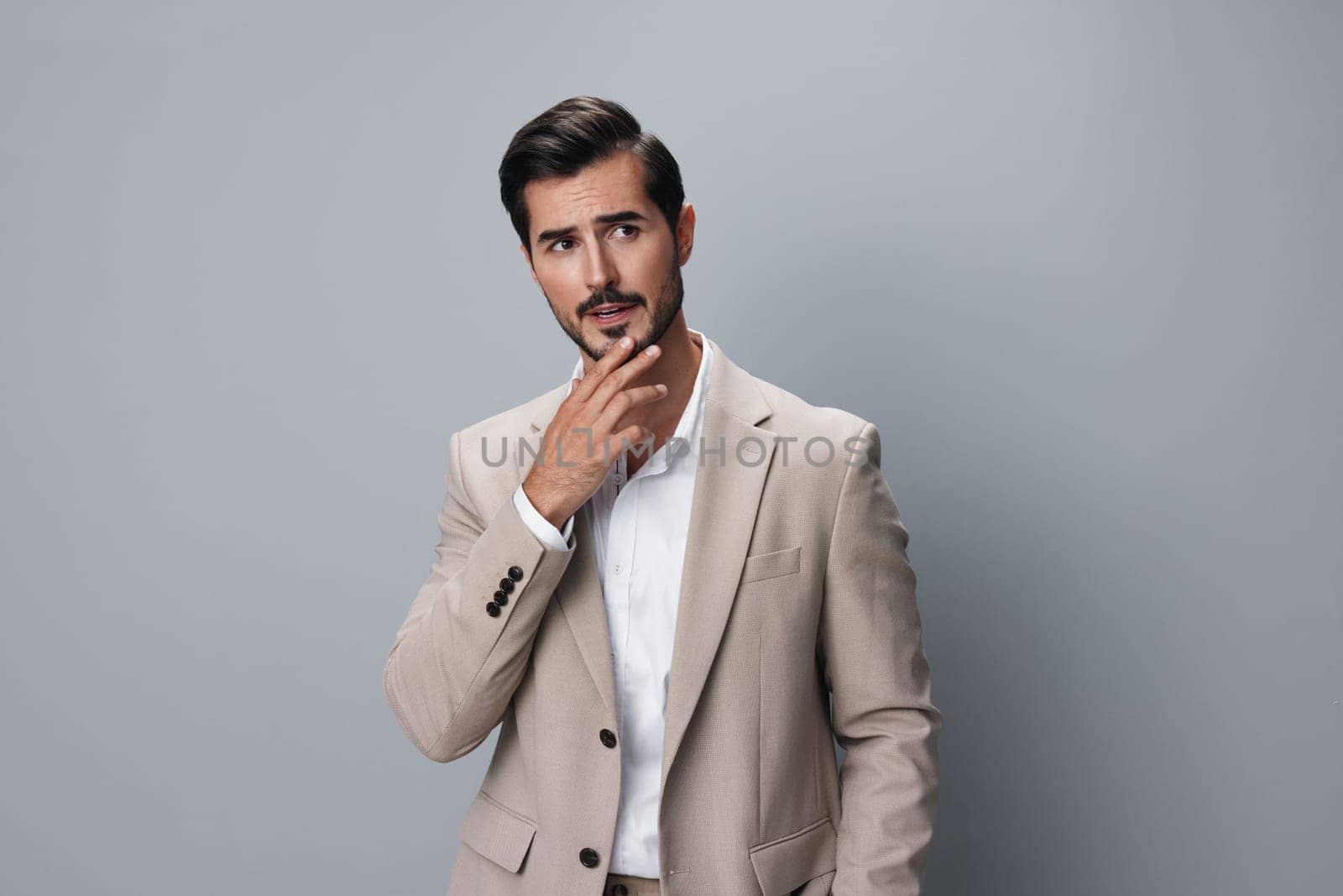 portrait man male tie entrepreneur suit posing corporate smiling beige sexy eyeglass business businessman happy white stylish standing copyspace job handsome