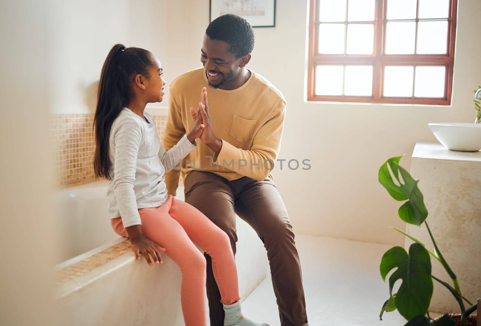 Black family, high five and happy child with father in home bathroom with love, care and support. Man and girl kid for a pep talk and communication with a smile, energy and celebration of trust by YuriArcurs