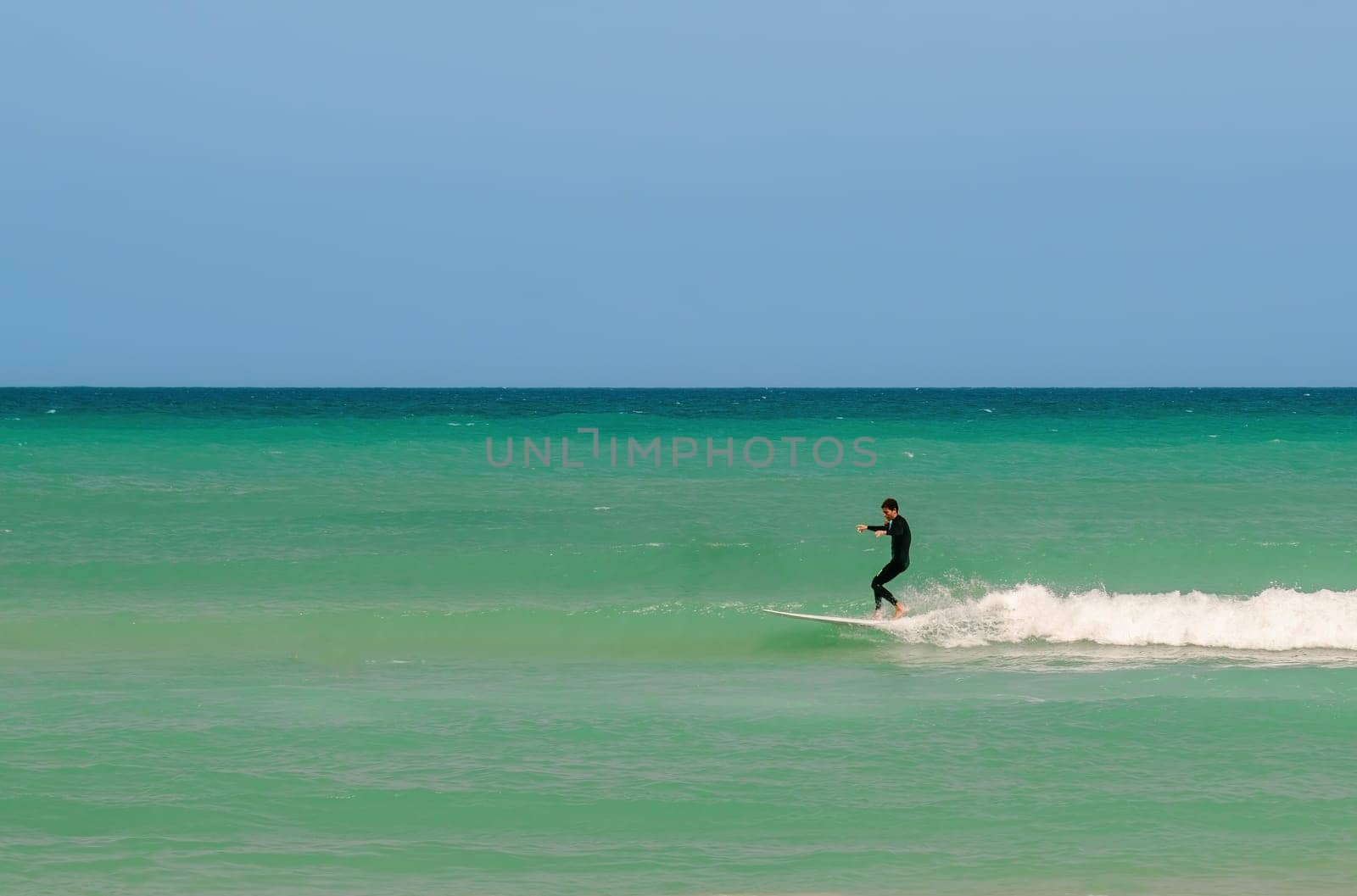 Surfing on a water board. Surfer ride the waves on the sea. Netanya, Israel. May 23, 2023 by Renisons