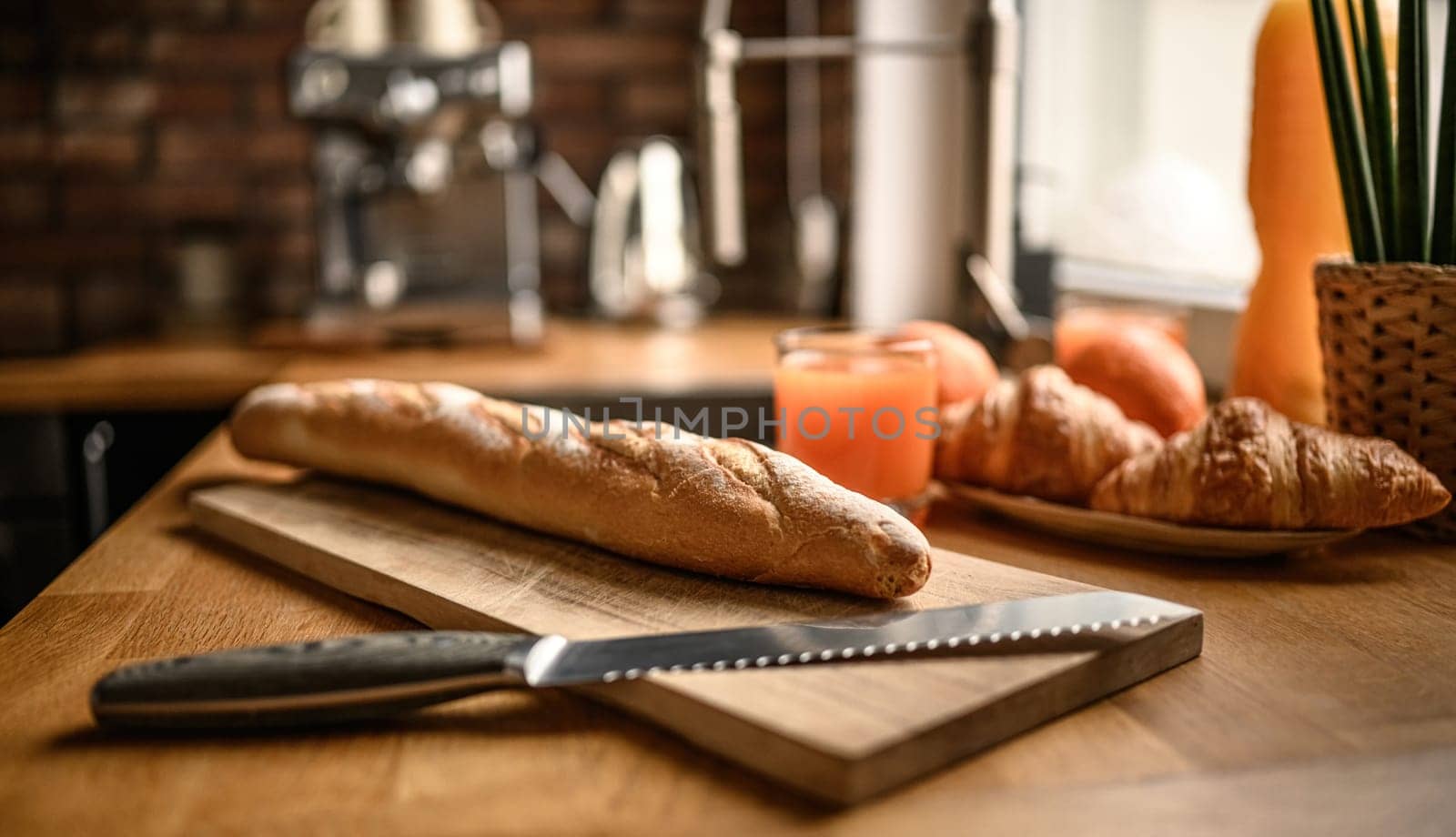 Fresh baguette on a cutting board at the kitchen by GekaSkr