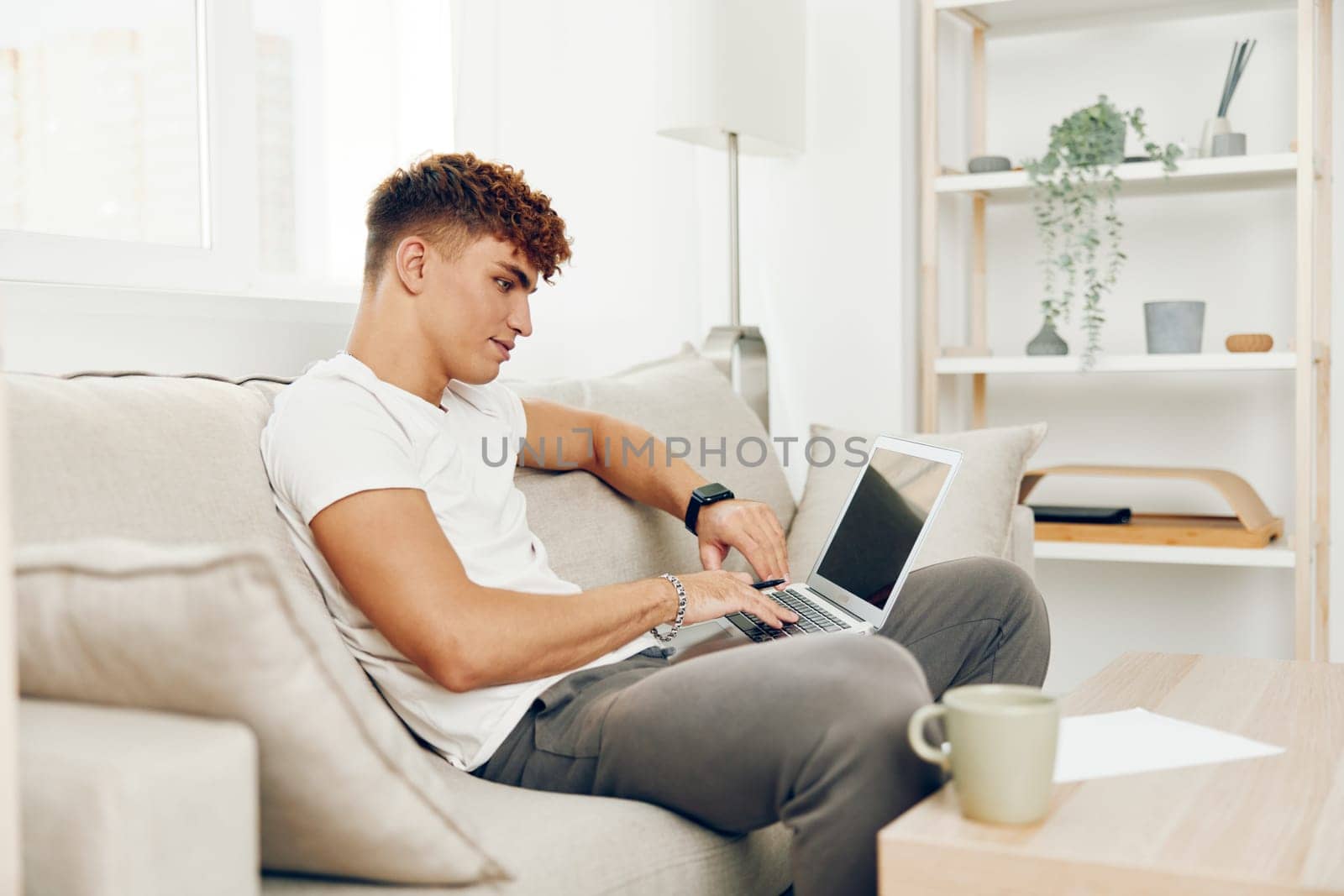 man interior laptop t-shirt sitting job laptop business browsing home person by SHOTPRIME
