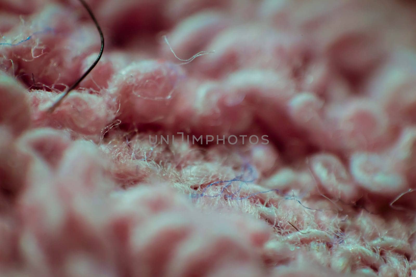 Macro closeup of soft pink fabric background.