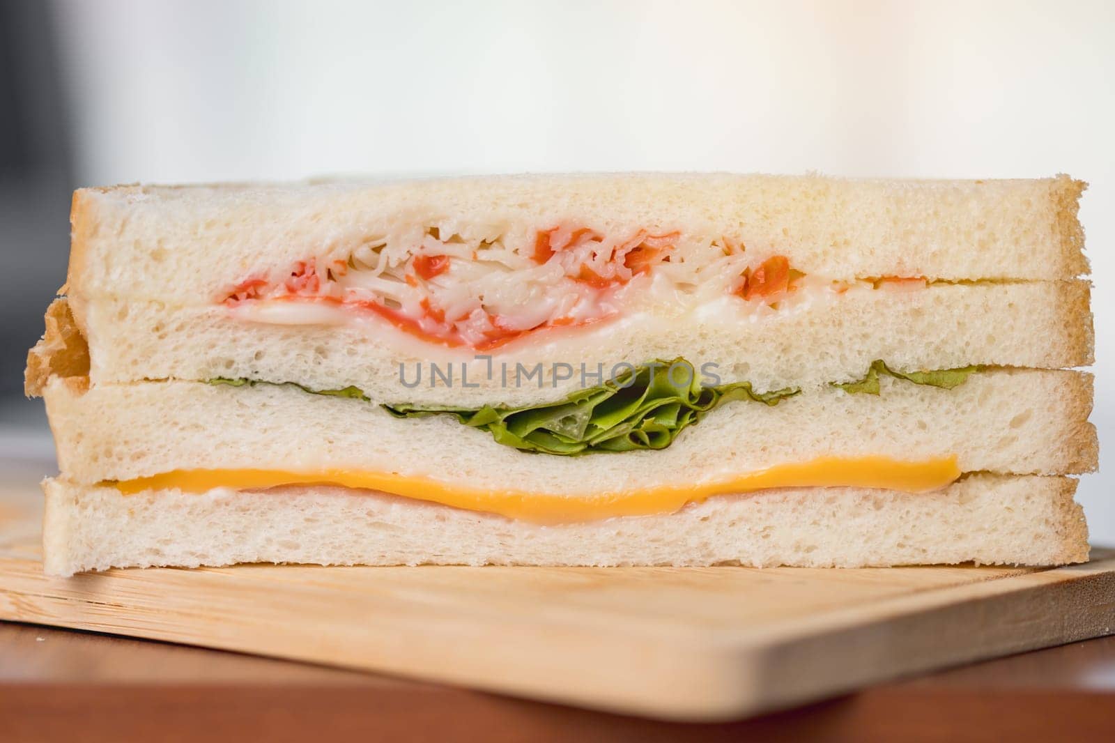 Delicious sandwich bread on a wooden table with blurred background for bakery, food and eating concept