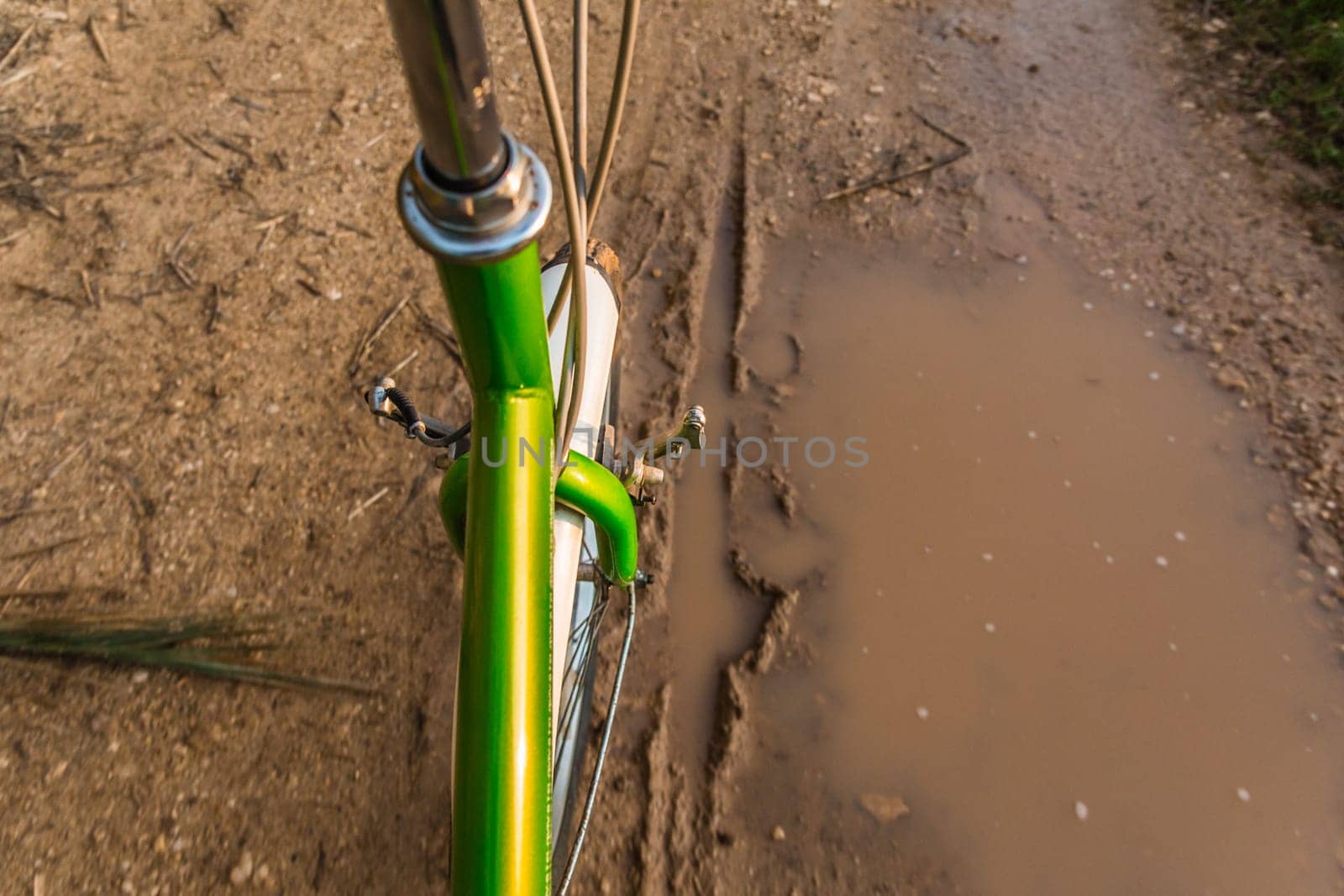 Bicycle ride through muddy dirt road.