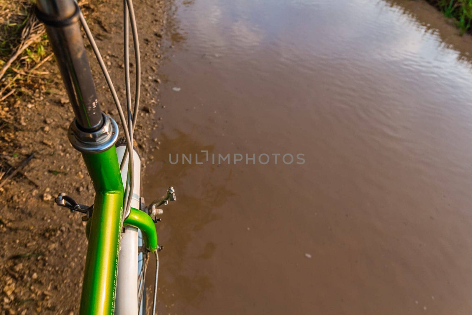 Bicycle ride through muddy dirt road.