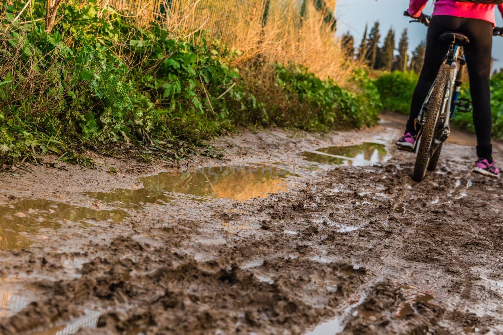 Bicycle ride through muddy dirt road.