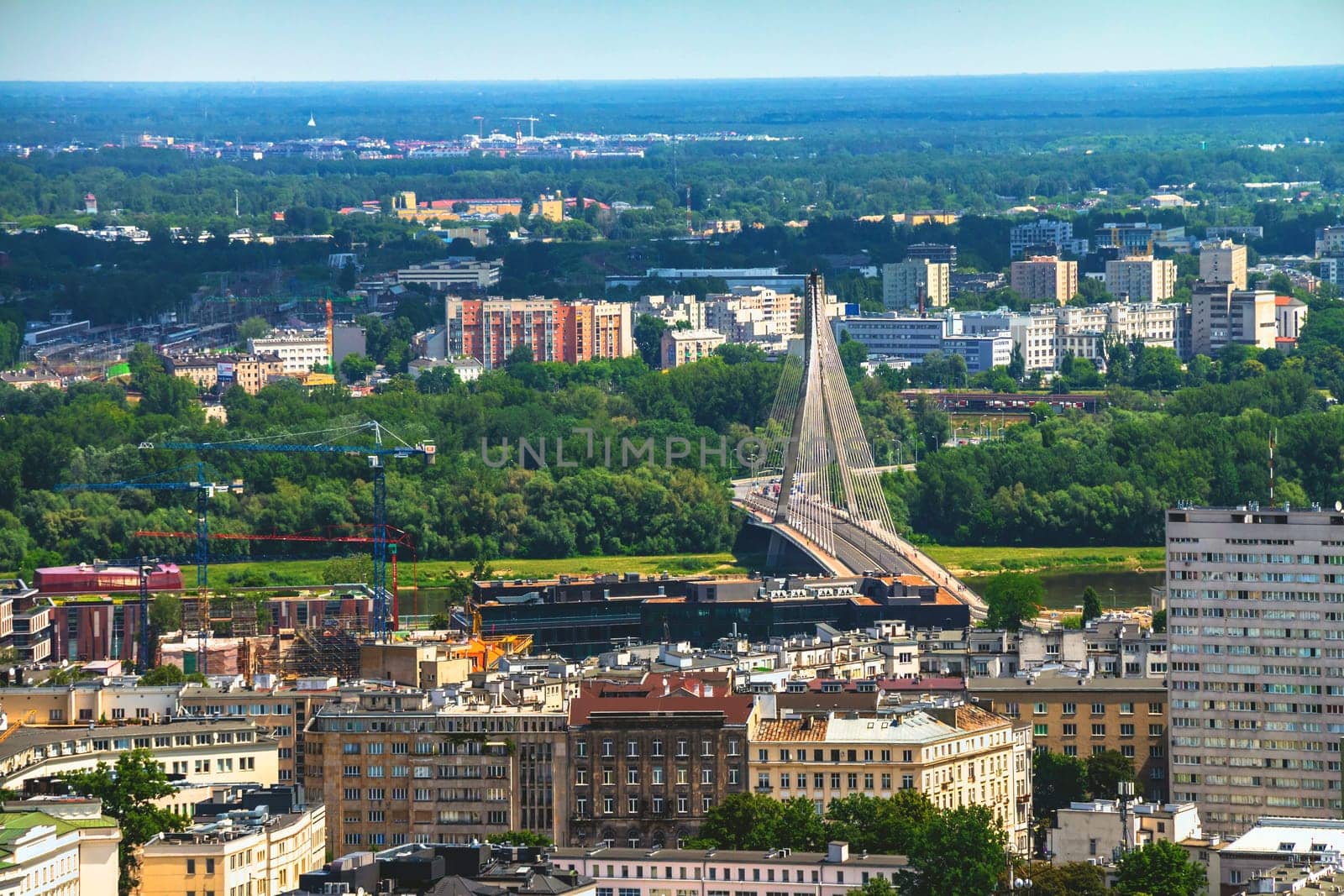 Aerial view of the Warsaw skyline buildings including Swietokrzyski Bridge over the Vistula river.