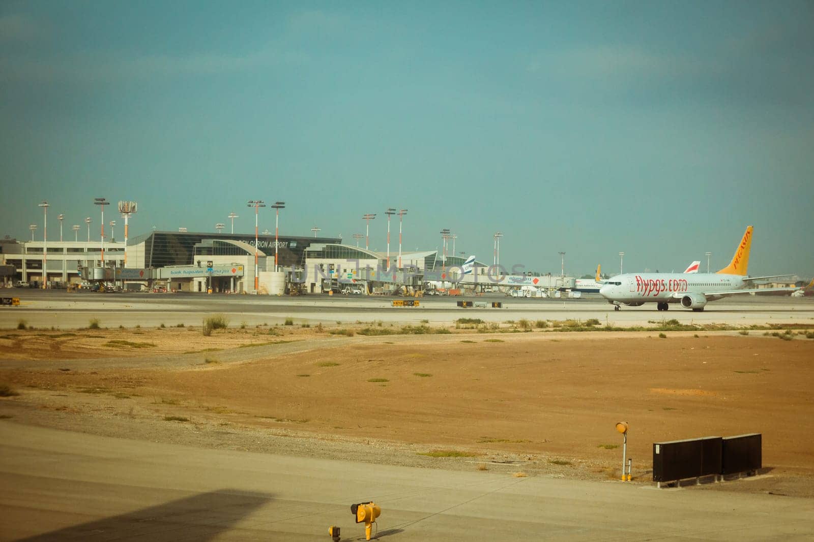 Tel Aviv, Israel - Sep 15, 2015: Flypgs airline commercial plane on the runway and terminal 3 at Ben Gurion International Airport.