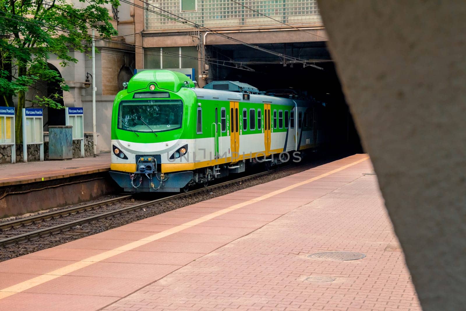 Electric passenger train arrives at the railway station in Warsaw Poland.