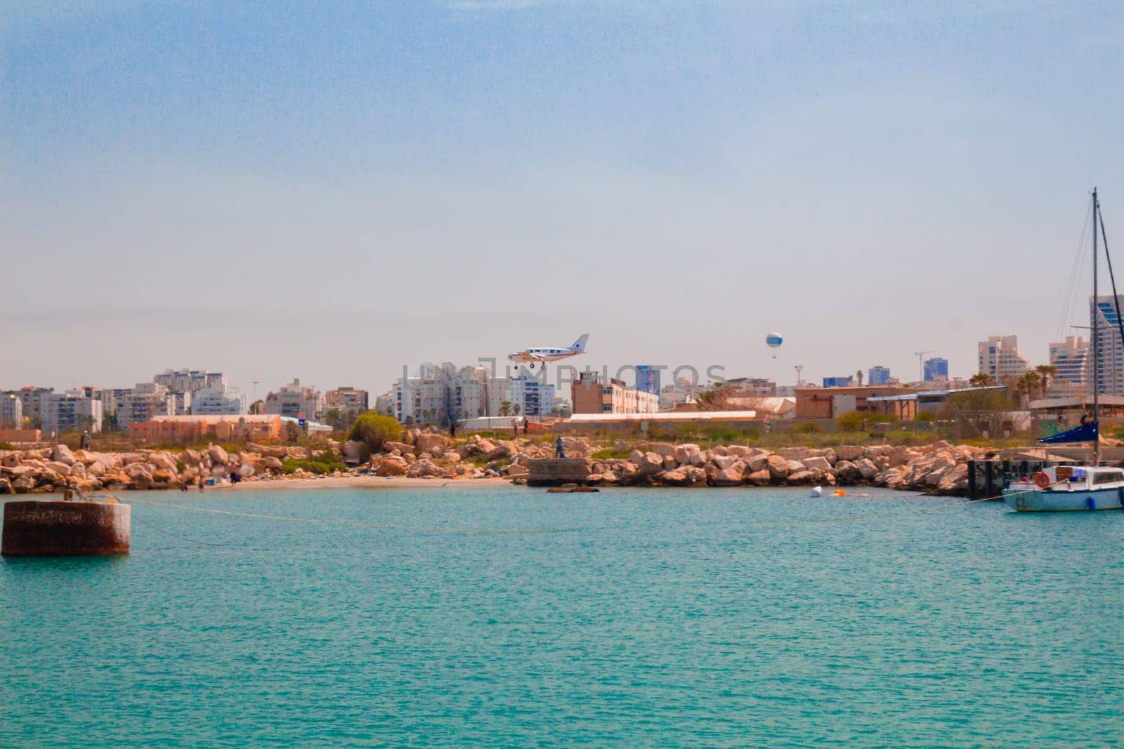 Light aircraft landing above the sea. Mediterranean coast, Tel Aviv, Israel.