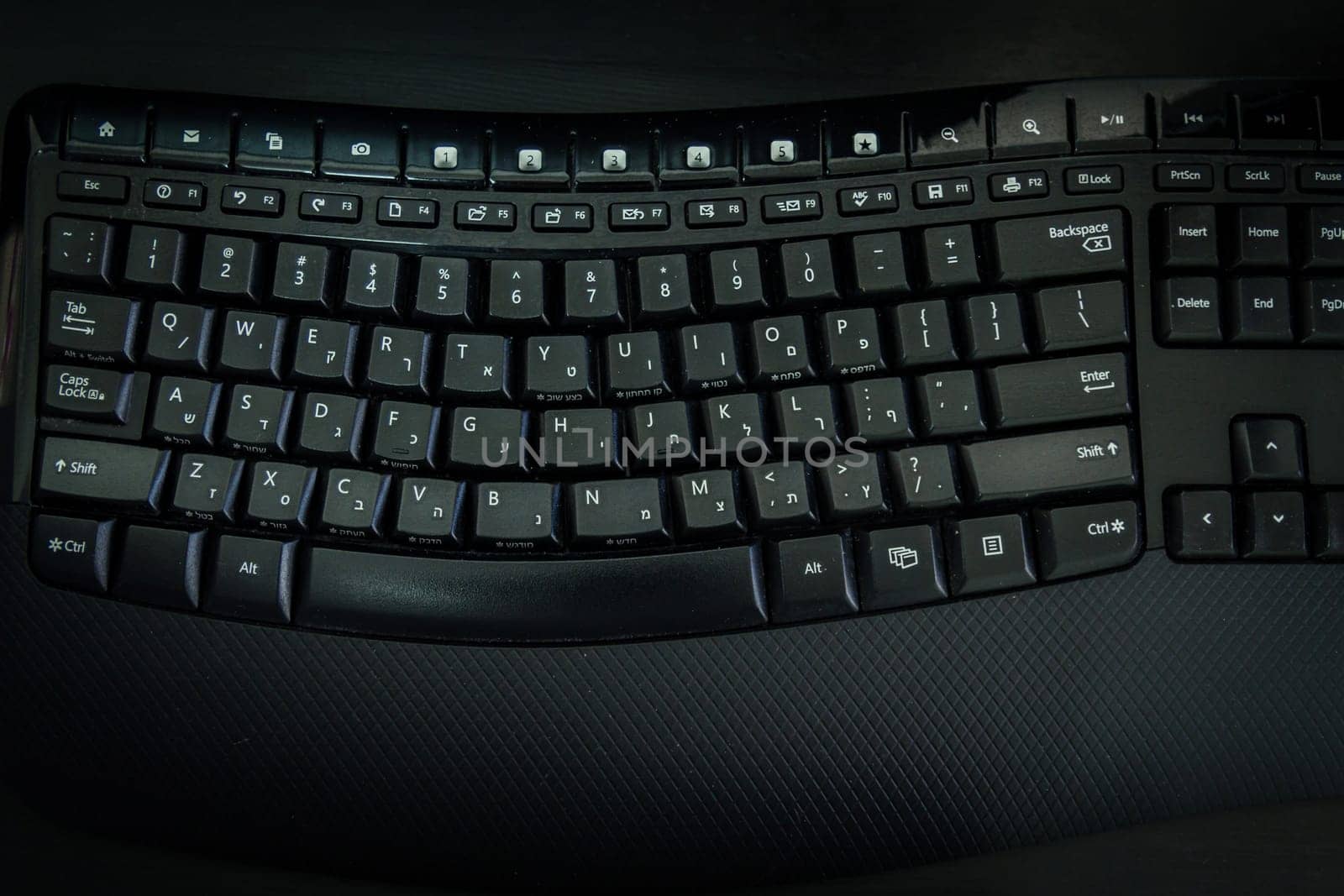 Keyboard with letters in Hebrew and English - Wireless keyboard - Top View -  Dark atmosphere