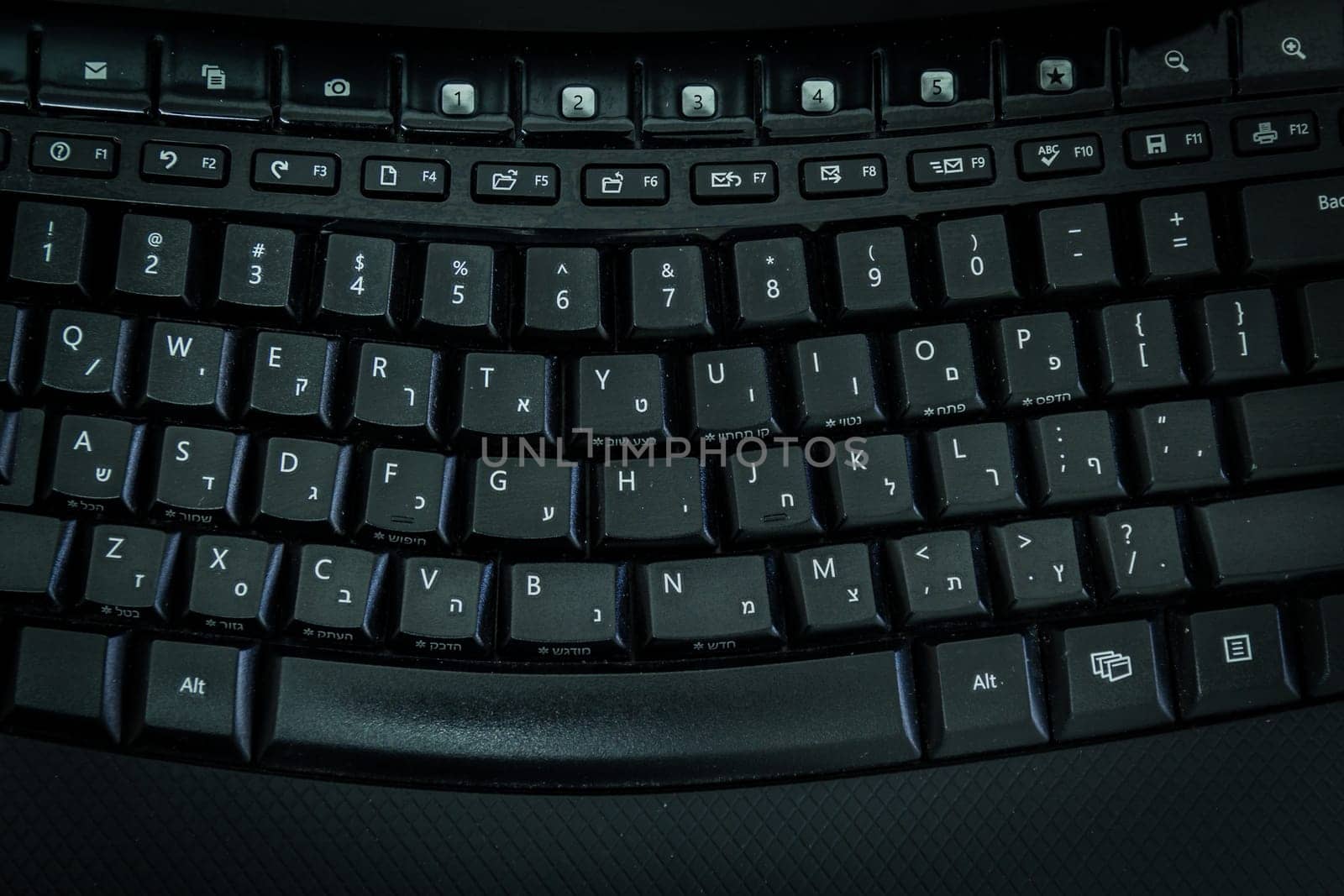 Keyboard with letters in Hebrew and English - Wireless keyboard - Top View -  Dark atmosphere