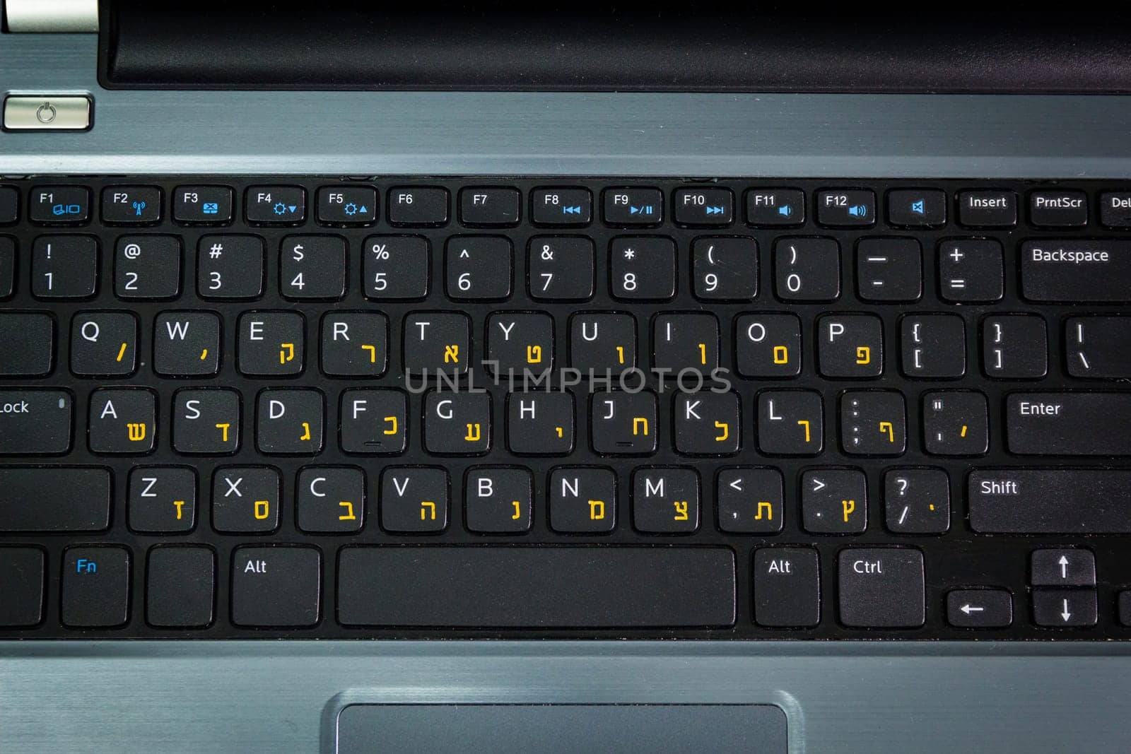 Keyboard with letters in Hebrew and English - Laptop keyboard - Top View -  Dark atmosphere