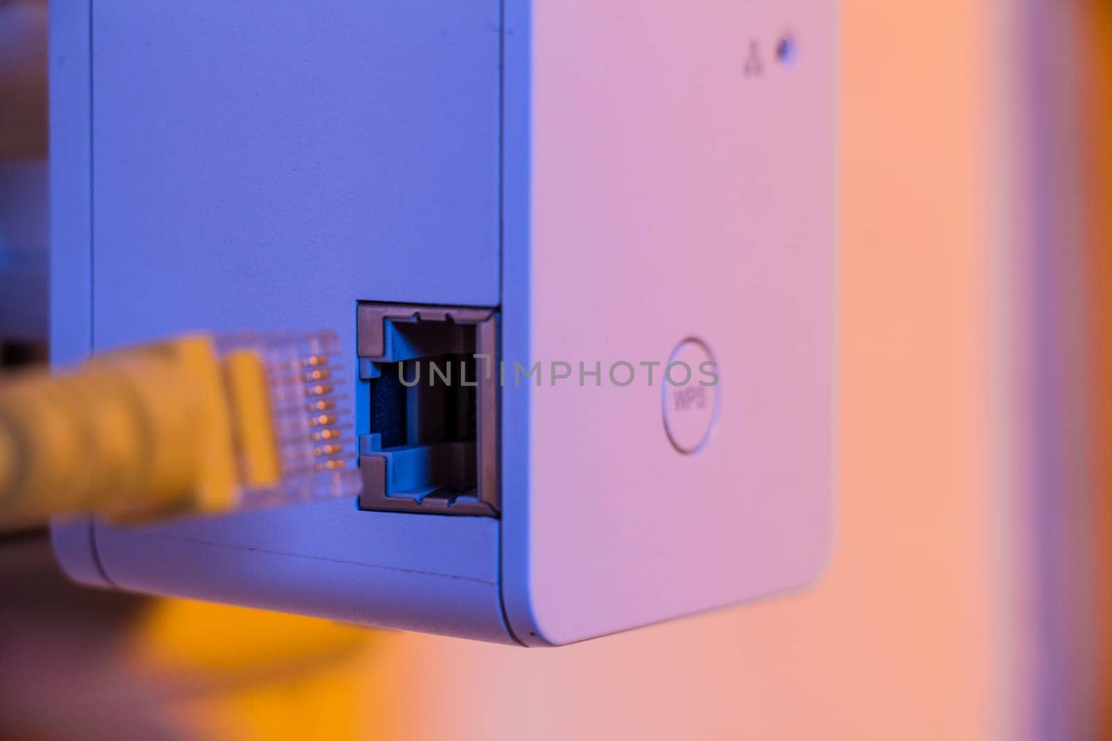 Insert ethernet cable into WiFi extender device which is in electrical socket on the wall. The device is in access point mode that help to extend wireless network in home or office.