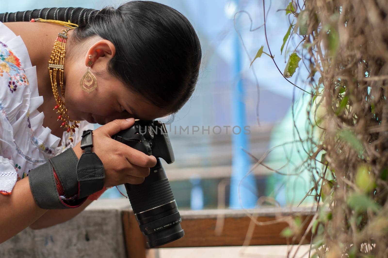 copy space of a photography student taking a photo with a reflex camera towards the ground. High quality photo