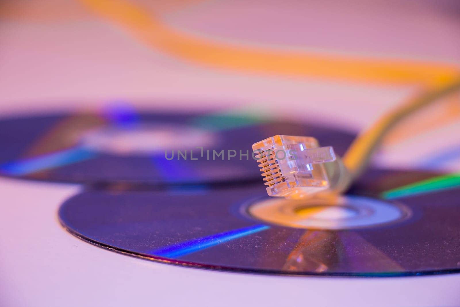 Closeup of Ethernet cable with it's reflection on blank disc.