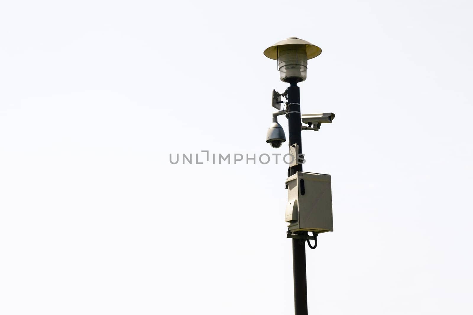 Surveillance cameras on street lamp.
Isolated on white background.
