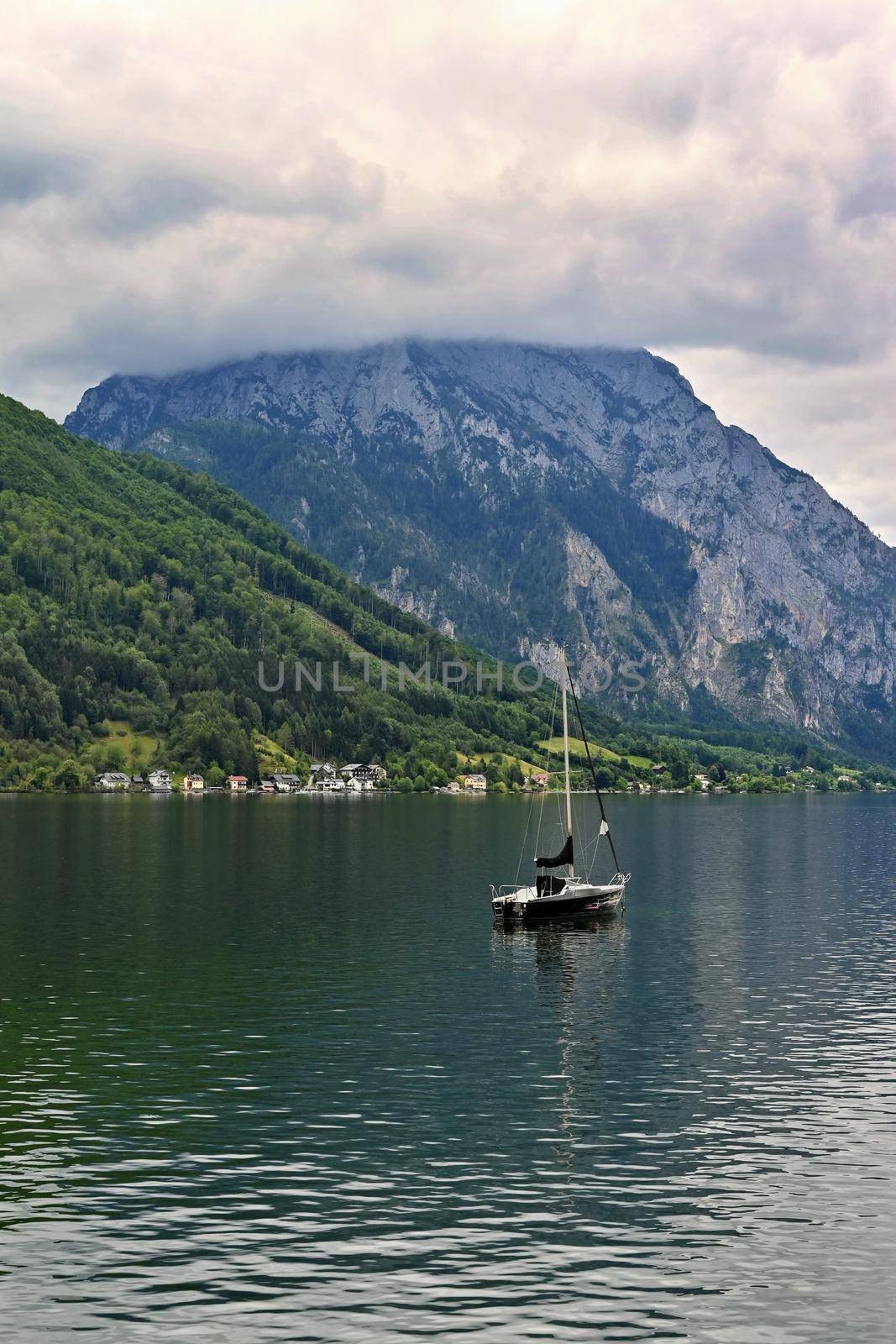 Beautiful misty and cloudy landscape with lake and mountains in summer. Natural colorful background. Traunsee lake in the Austrian applause - Gmunden.