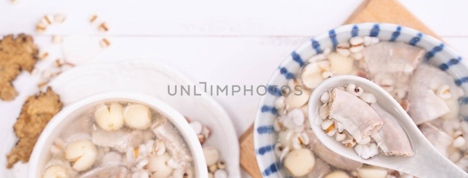 Tasty Four Tonics Herb Flavor Soup, Taiwanese traditional food with herbs, pork intestines on white wooden table, close up, flat lay, top view by ROMIXIMAGE