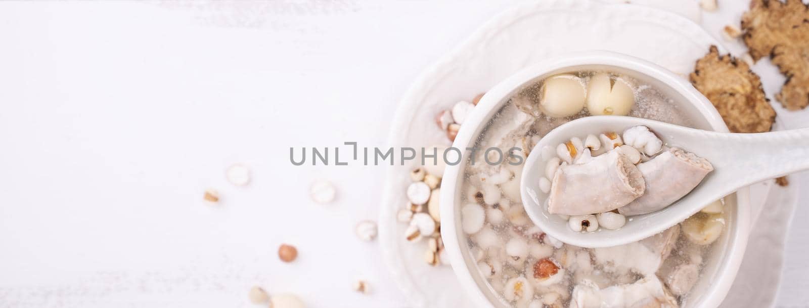Tasty Four Tonics Herb Flavor Soup, Taiwanese traditional food with herbs, pork intestines on white wooden table, close up, flat lay, top view by ROMIXIMAGE
