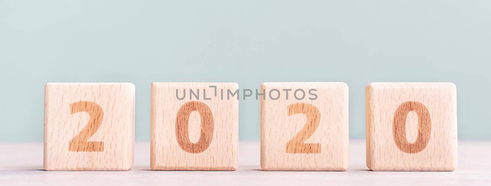 Abstract 2020, 2019 New year target plan design concept - wood blocks cubes on wooden table and pastel green background, close up, blank copy space.