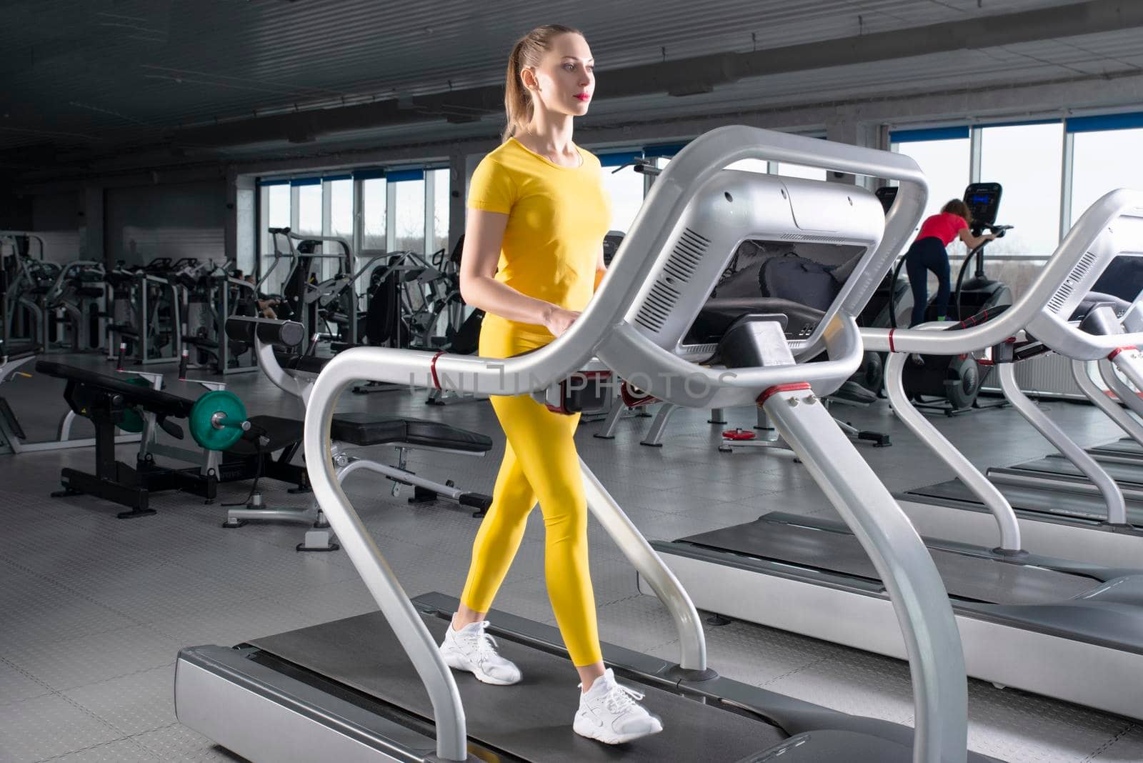 Young woman running on treadmill