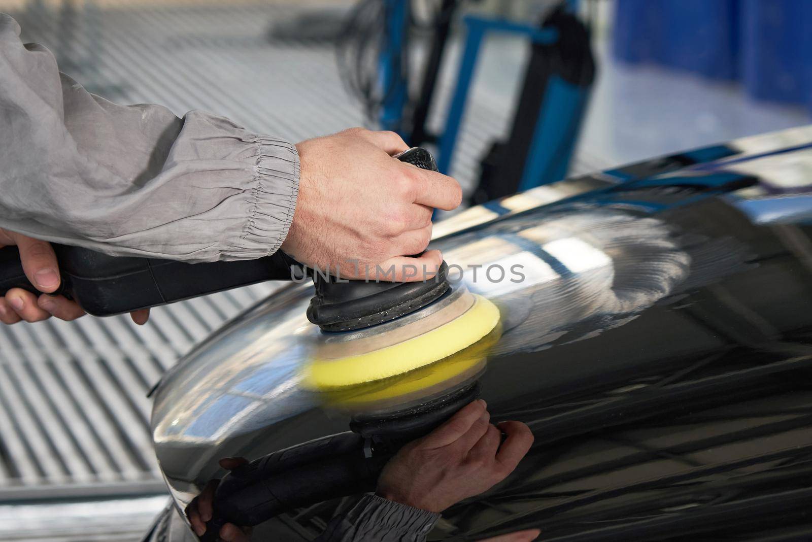 hands holding the work tool polish car, Auto Mechanic Polishing Car