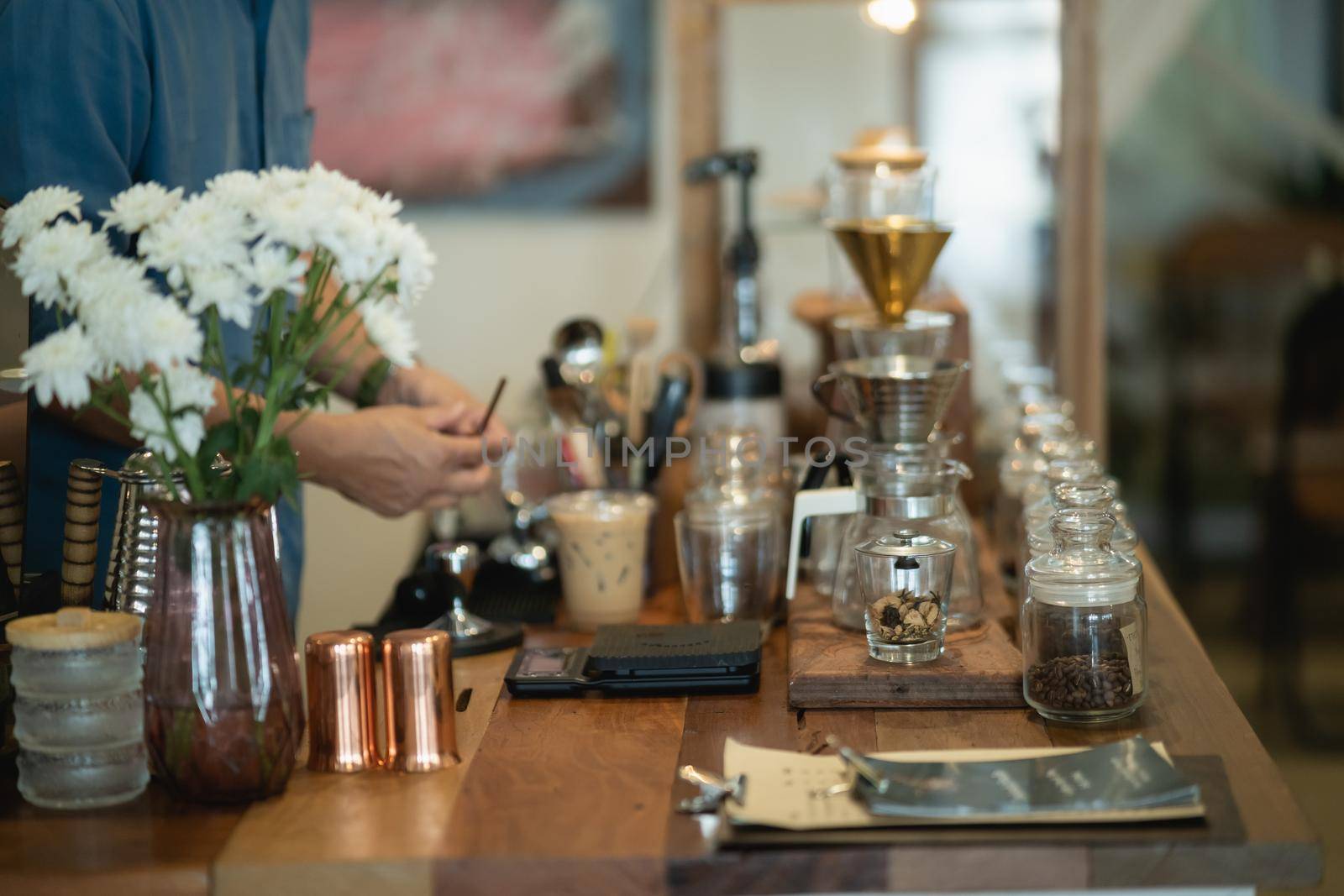 barista making hot coffee in the coffee shop by Wmpix