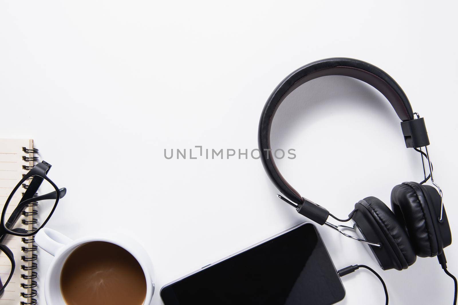 Top view, headphone, mobile, coffee and notebook music concept. Flat lay music concept on white background