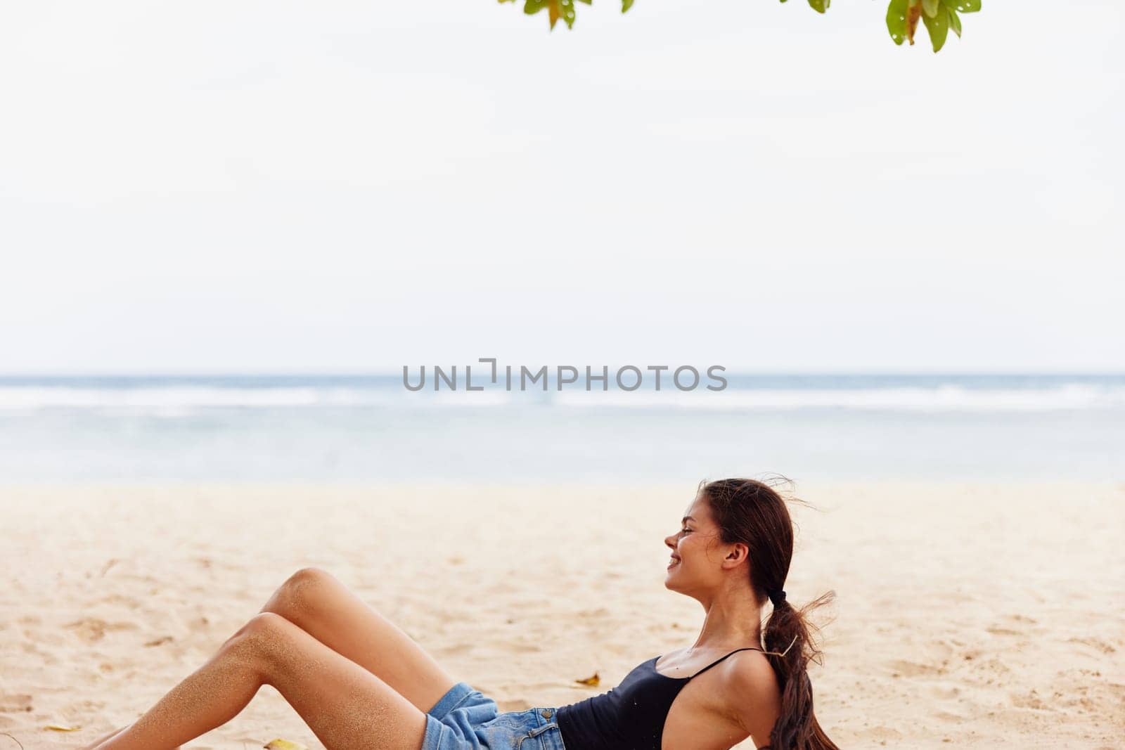 young woman sand smile beach freedom travel nature sea sitting vacation by SHOTPRIME