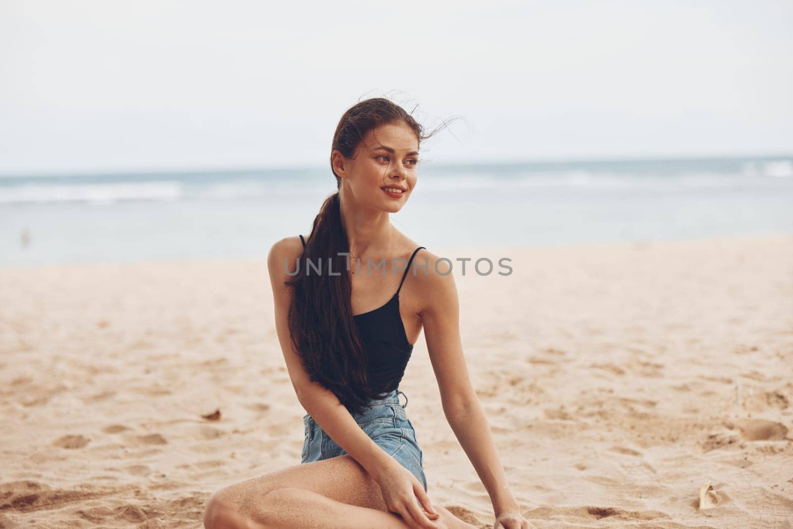 sea woman water freedom smile lifestyle coast summer sitting sand holiday female nature adult relax travel alone vacation beach outdoor happy