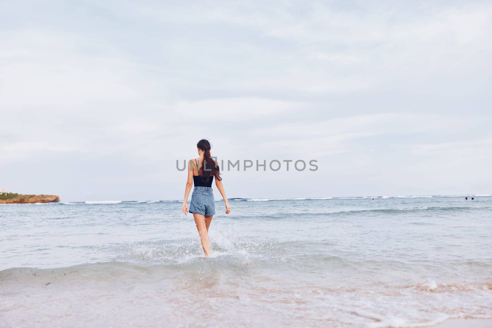 woman beach tan body happy positive young leisure lifestyle sand travel space running sunset summer copy ocean flight female smile walking sea