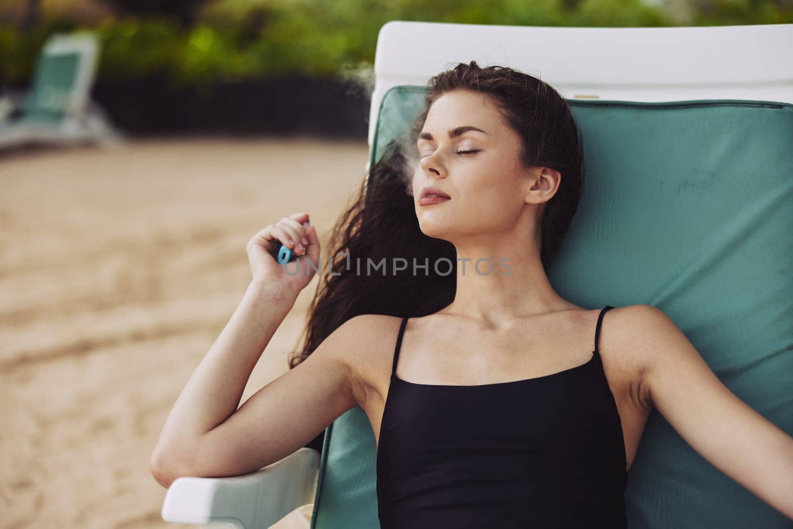 woman holiday relaxation blue lifestyle beach vacation smiling hat tropical sitting chair relax sand ocean girl resort sea beach lying sunbed young