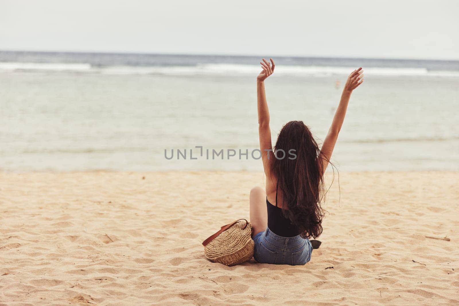 woman sand water sea carefree freedom ocean female sun travel smile sitting lifestyle nature summer beach vacation holiday young person tan