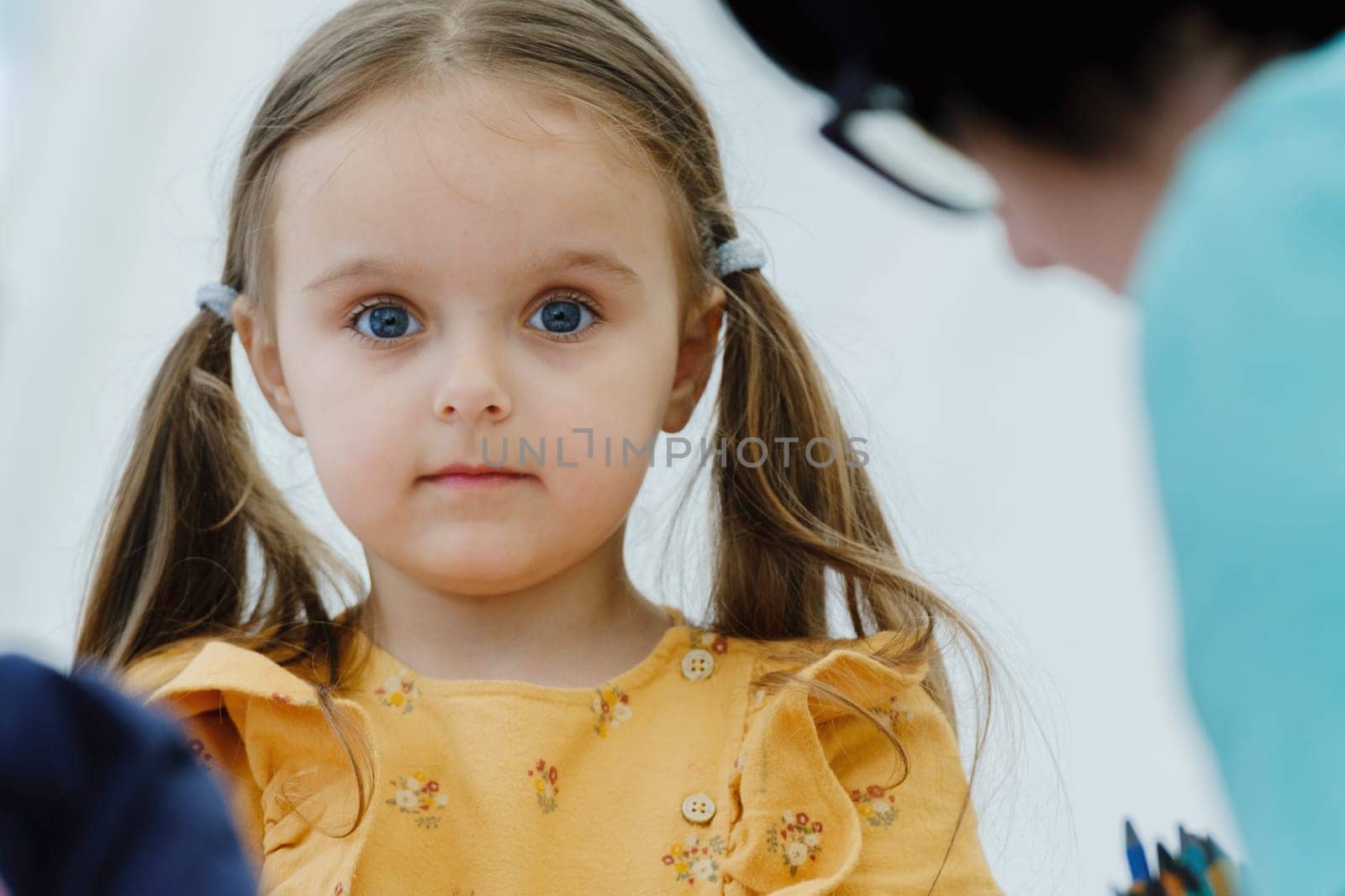 Cute european kid girl painting with colored pencil. Kindergarten children education concept. by leonik