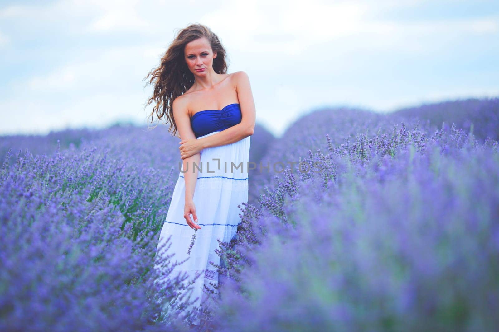 Woman standing on a lavender field by Yellowj