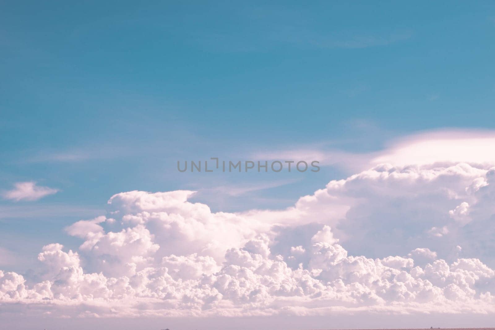 huge White fluffy cloud against  blue sky summer abstract weather background.