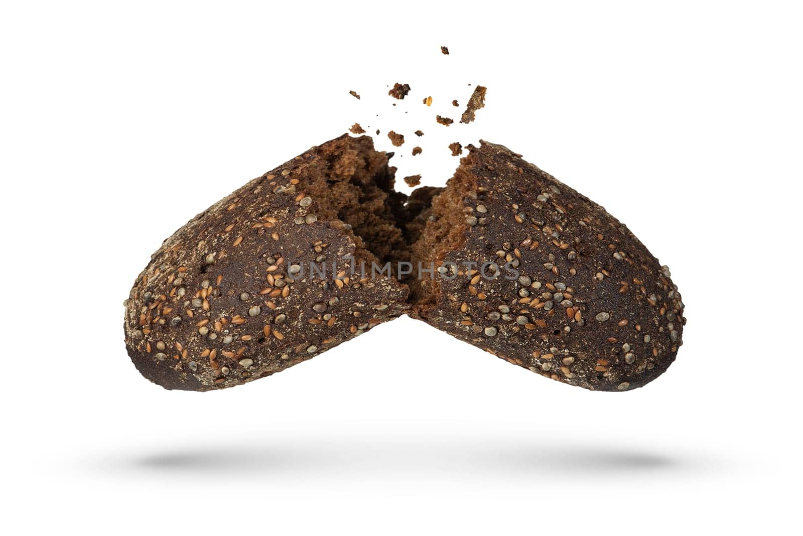 Loaf of black rye bread on a white isolated background. Failed breakfast concept. The bread is broken into 2 parts, crumbs are pouring out of it. High quality photo