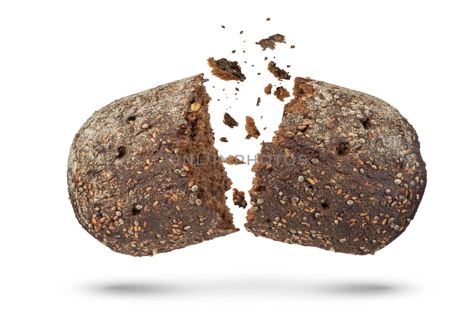 Loaf of black rye bread on a white isolated background. The bread breaks into 2 parts, crumbs fall out of it. view from above. by SERSOL