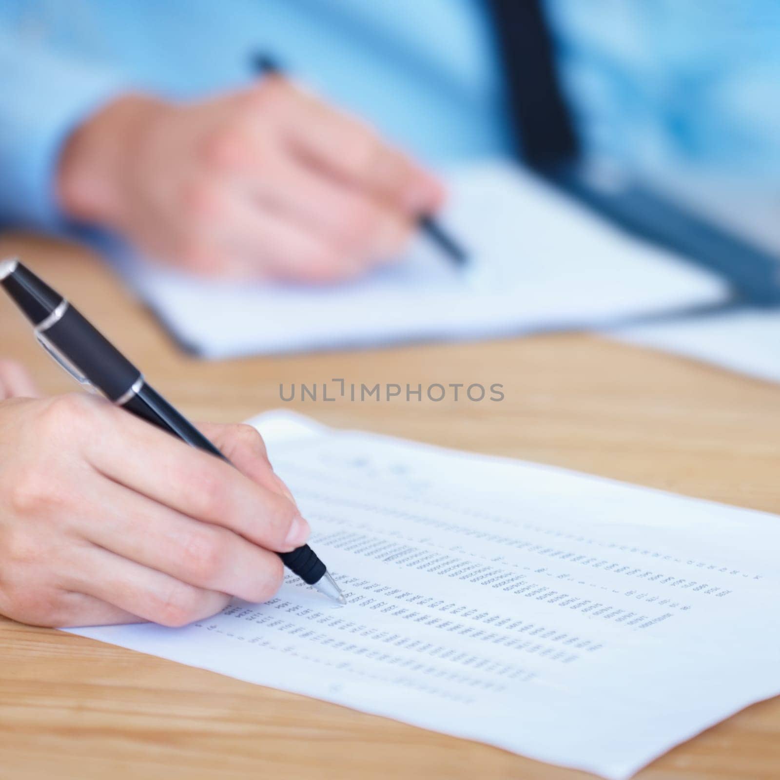 Business people, hands and writing on finance spreadsheet for accounting, budget or expenses on form. Hand of accountants working on financial report, documents or paperwork with pen on office desk.