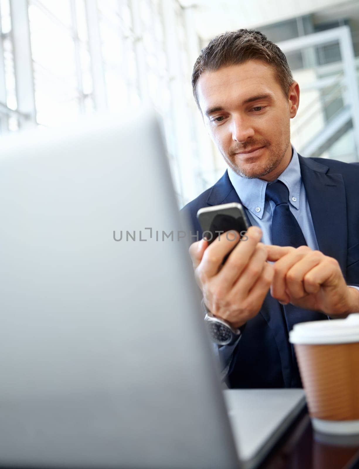 Businessman, smartphone and technology with networking with company communication or social media scroll. Contact, online and email, phone and typing with employee in professional corporate lounge.