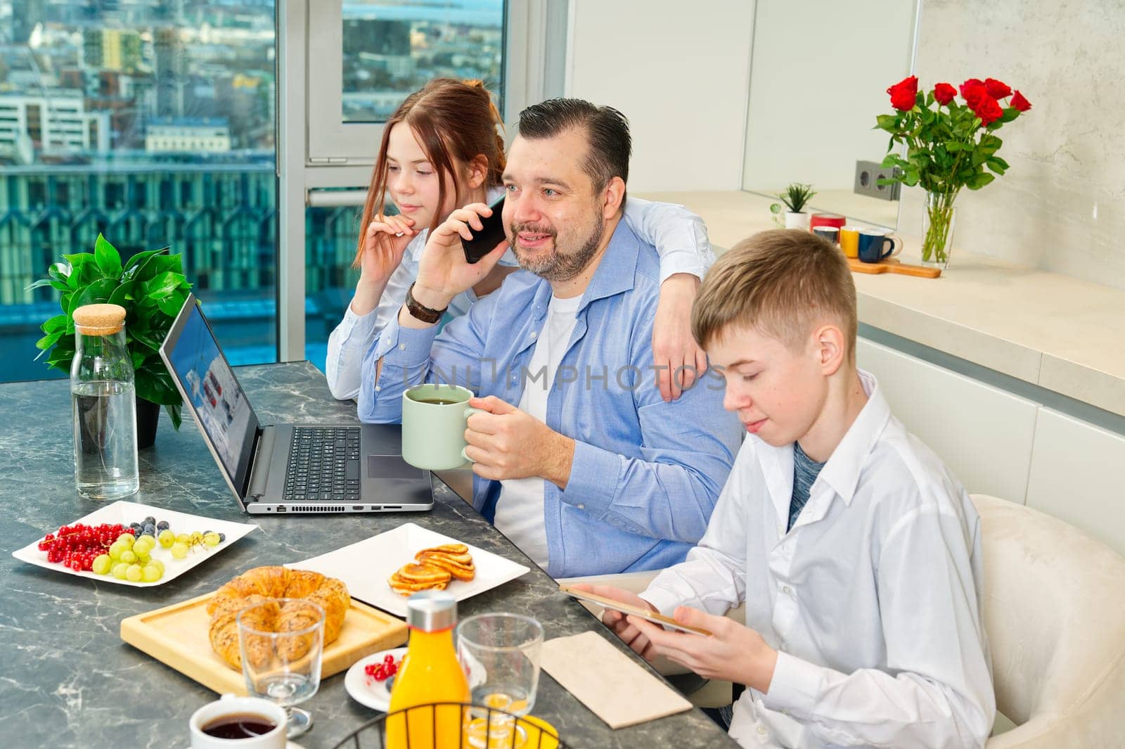 Successful business man having breakfast and working from home. having breakfast with childrens by PhotoTime