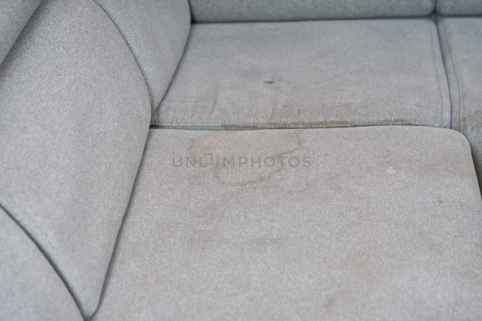 Dirty, stain, blot, fleck of water on the fabric, textile sofa. Dirty textile sofa chemical cleaning by PhotoTime